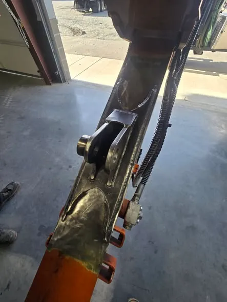 Repaired pivot connection on a piece of heavy equipment