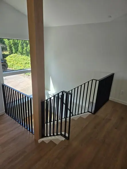 Custom black steel railing installed in a home